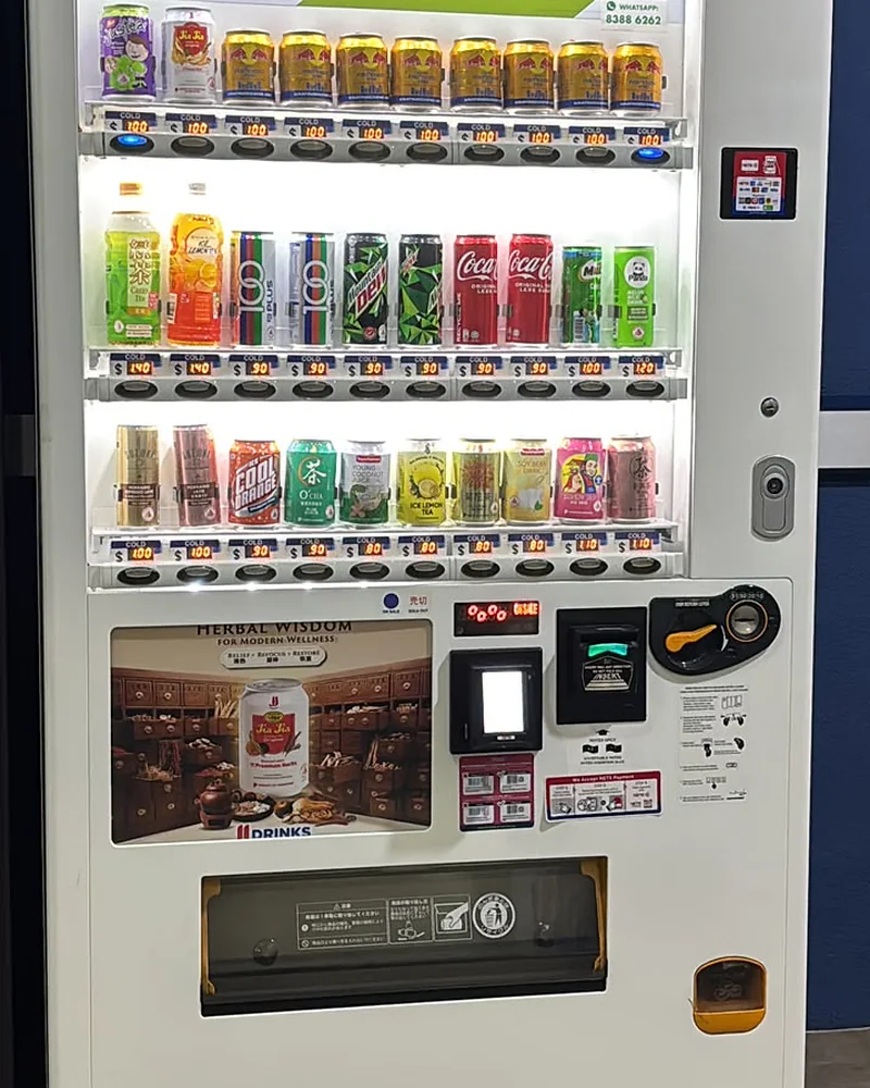 An Achieva drinks vending machine installed indoors, stocked with chilled cans and bottles