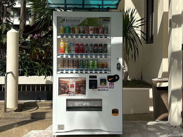 An Achieva drinks machine in a sheltered walkway at a Singapore condominium