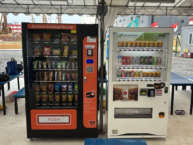 Achieva snack and drinks machines in a canteen shelter on a Singapore construction site