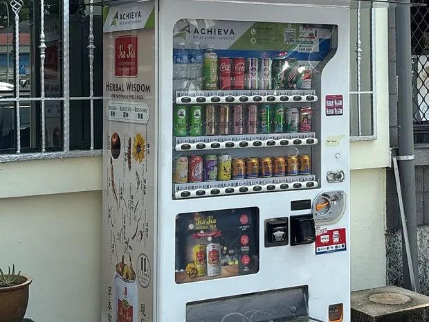 An Achieva drinks machine at a roadside spot in a Singapore neighbourhood